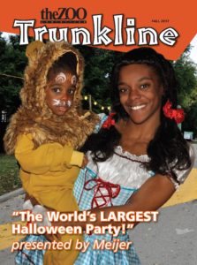 image - theZOO fall 2017 trunkline, "the world's largest halloween party/!" presented by Meijer, with young lady in princess dress holding young child in lion costume w/face painting, both smiling
