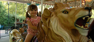 Girl on Carousel Lion
