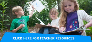 banner - 3 children, sitting, with clipboards, where they are taking notes, during teaching session, with green trees, bushes in background, click here for teacher resources