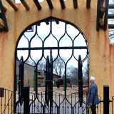 New Africa Opening - main entrance archway into elephant enclosure, with john walczak admiring archway, with elephant in the yard