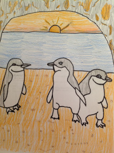 image - kid's drawing of 3 blk/white penguins, standing by blue water, with sun coming up in the sky orange/yellow sky