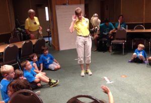 photo - zoo docent, showing backyard raptor, to a class of zoo day campers