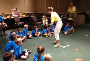 photo - zoo docent displaying backyard raptor to zoo day campers, boys and girls, in classroom