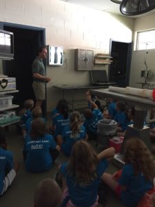photo - zoo veterinarian, showing x-rays, to a group of Safari zoo day campers, at vet camp hospital