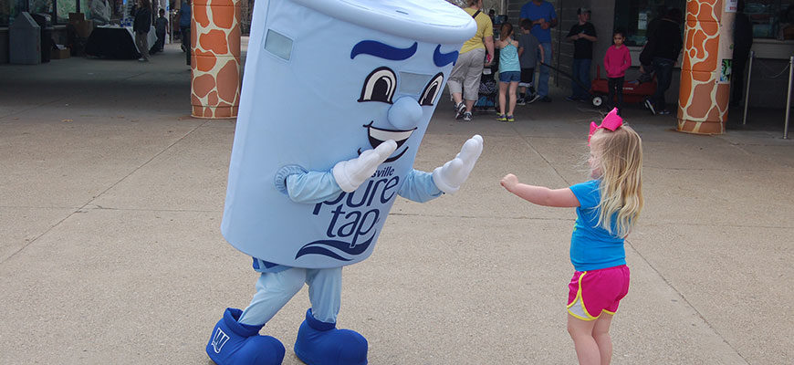 photo - mascot of louisville pure tap water, giving high five to a child on the zoo plaza