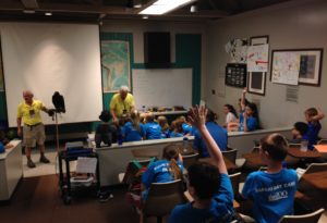photo - (upside down) classroom in gheens building, keeper is giving a raptor presentation to zoo day campers