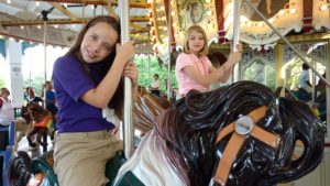 portland elementary girls ride merry go round