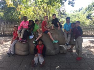 wilt students sit on top of rhino statue