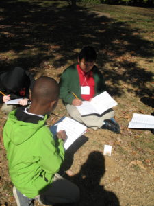 shelby elementary students do activity in grass