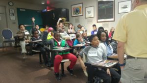 Cochran elementary students raise hands in class