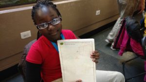 Goldsmith girl shows off her drawing of a house