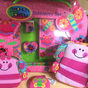 image - gift shop items butterfly themed, pink pillows, purses, stationery set, decorated with pink smiley faces on them, also has variety of multi colored butterflies and flowers on said items