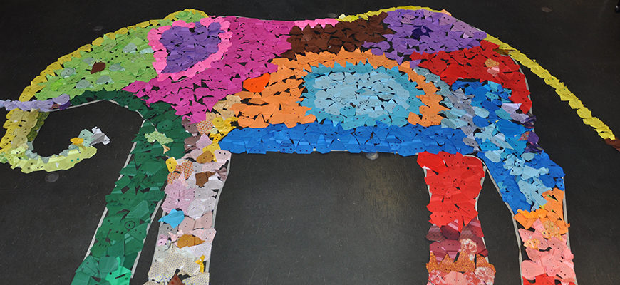 image - blk background, origami elephant made with different colored, torn up pieces of paper, reds, blues, yellows, pinks, oranges, greens, whites, purples, browns, very beautiful finished art work