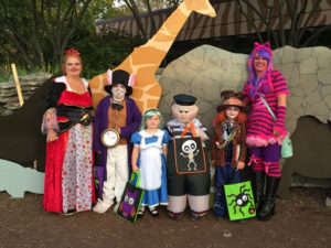 photo - group of costumed adults and kids, dressed as alice in wonderland characters from the johnny depp version of the disney movie