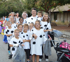 photo - family of visitors dressed in halloween homemade dalmation costumes, with other costumed visitors, waiting in line to get into the zoo