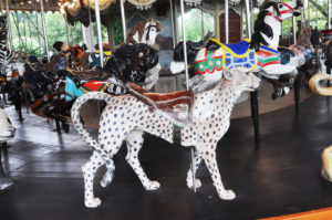 photo - carousel animal ride white with black spots cheetah, with red saddle