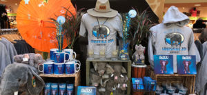 photo - of gift shop attire for zoo, coffee cups, stuffed animals, umbrellas, hats, glasses w/zoo logo on them, for purchase by visitors