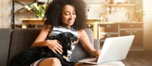 Woman on computer with dog