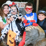 Family in costume with gold GIF banner
