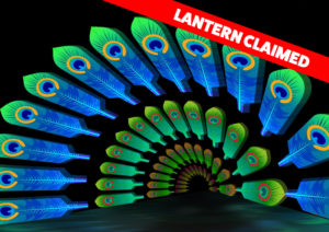 graphic - Lantern Claimed in red box. 4 rows of circular line of feathers, larger to smaller in size, variety of colors, blue/grn, grn/orange/green/orange and orange on dark background
