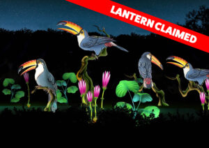 graphic - highlighted Lantern Claimed in red box, with scene of white, yellow, gray, red feathered toucans with yellow striped black tipped bills, sitting on variety of tree , with pink flowers with green leaves, with dark bushes in background with nighttime sky
