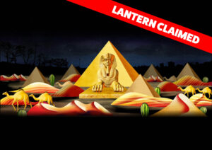graphic - Lantern Claimed highlighted in red box, scene is variety of gold pyramids with gold sphinx, mounds of reddish gold sand dunes, gold colored one hump camels, and green cactus with nighttime dark sky